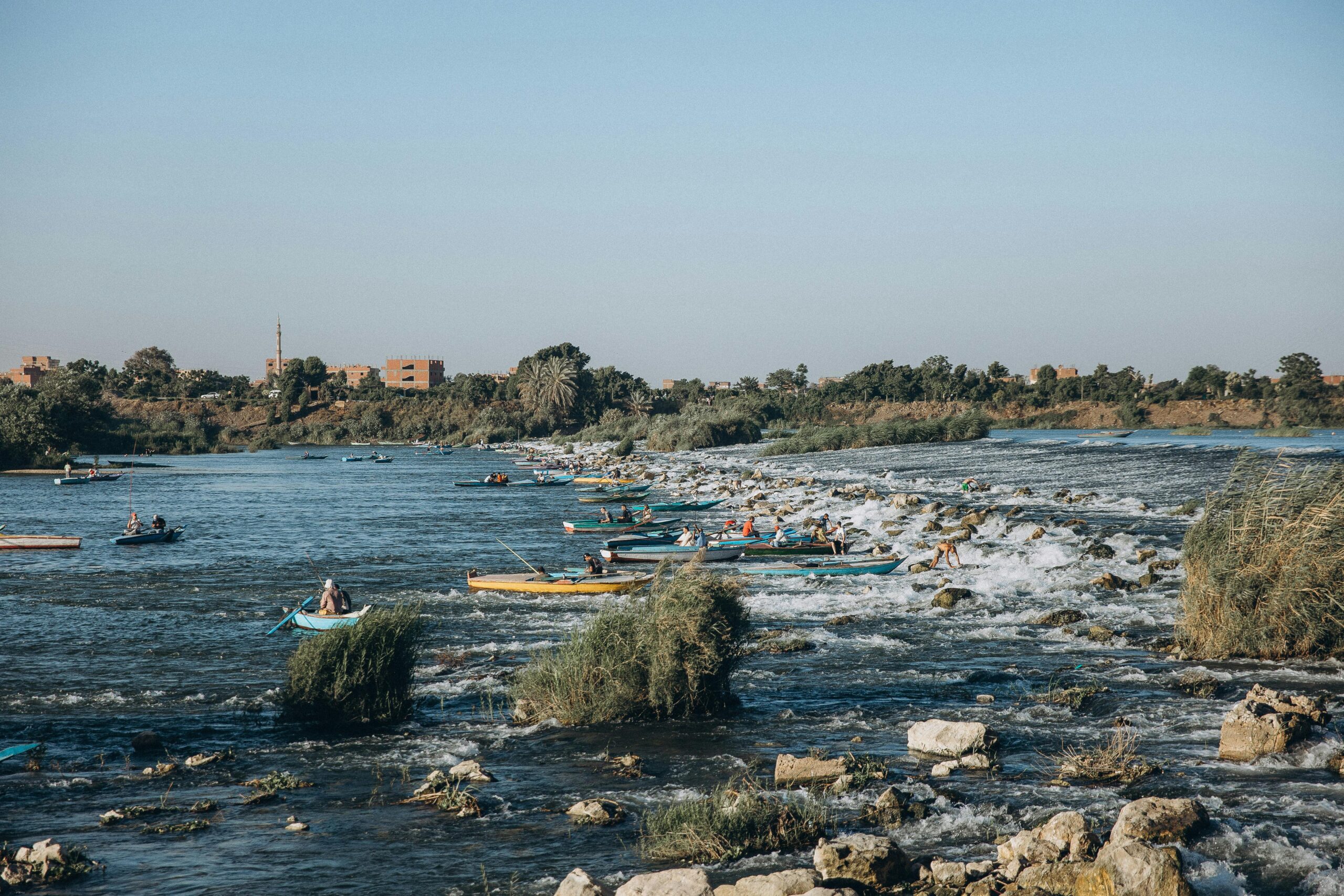 Kayakers navigate the tranquil waters of the Nile at Al Qanatir Al Khayriyyah, Egypt.