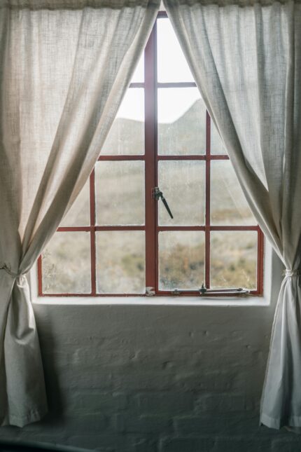 Soft-light interior showing serene landscape through framed window.